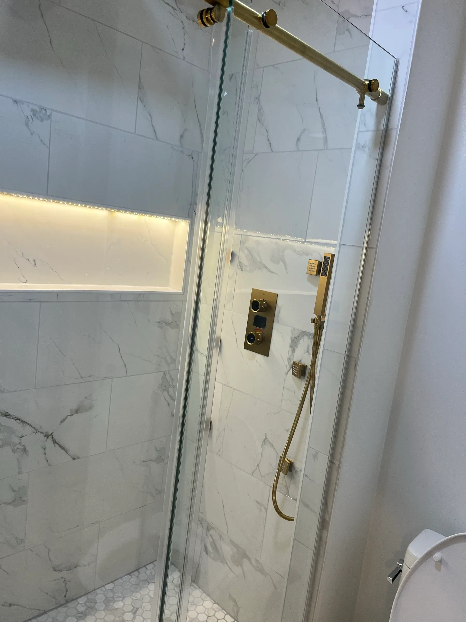 Finished shower with gold fixtures